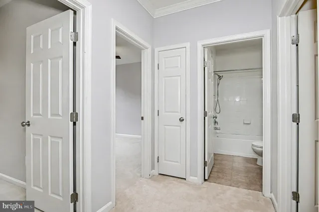 an empty room with a bathroom and a window