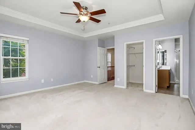 a front view of a house with a tree