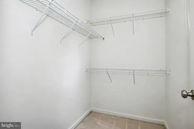 front view of a brick house with a large door and a potted plant