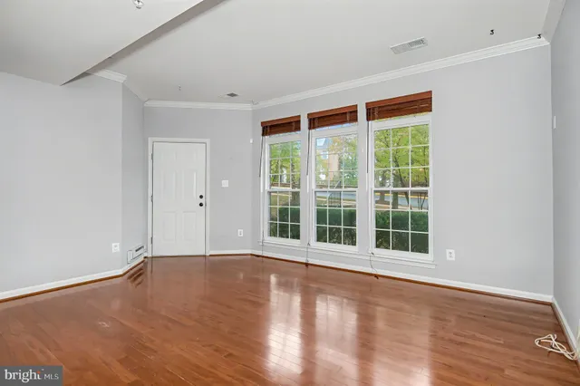 a view of a dining room with furniture a kitchen and chandelier