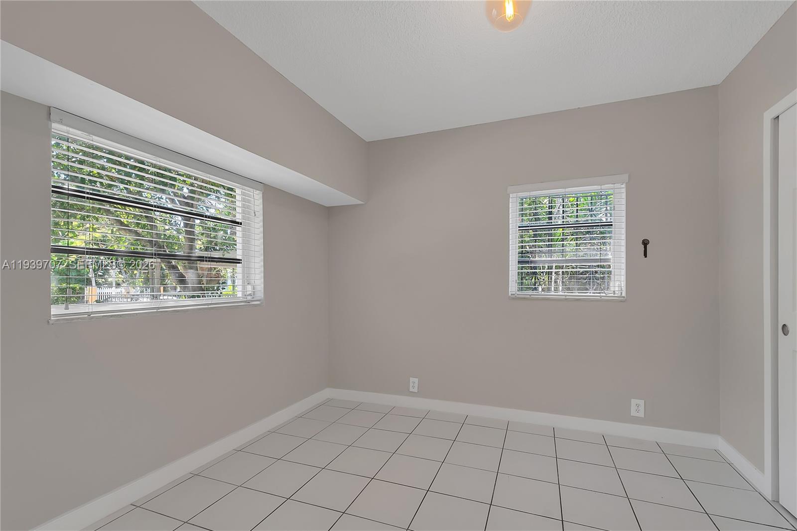 2327 Southwest 22nd Terrace, Unit FRONT Miami, FL 33145 - Photo 17 of 29 an empty room with windows