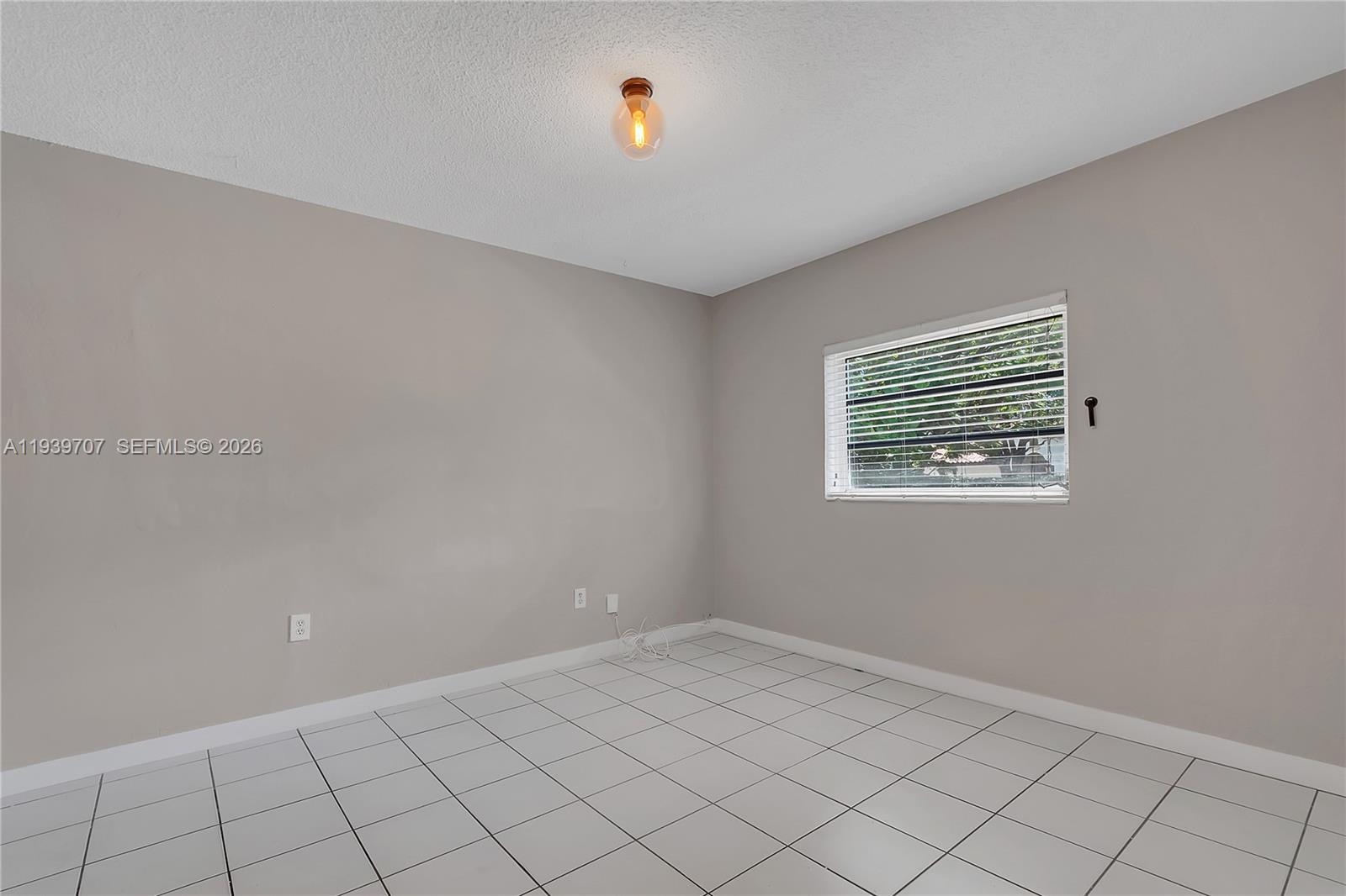 2327 Southwest 22nd Terrace, Unit FRONT Miami, FL 33145 - Photo 19 of 29 a view of an empty room and window