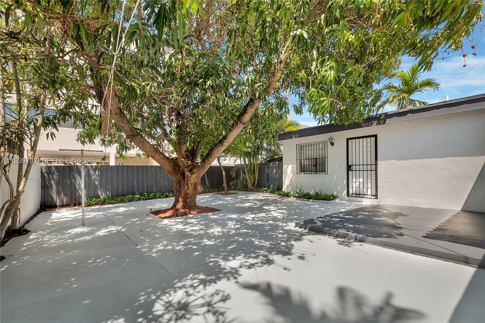 2327 Southwest 22nd Terrace, Unit FRONT Miami, FL 33145 - Photo 23 of 29 a tree in front of a white house
