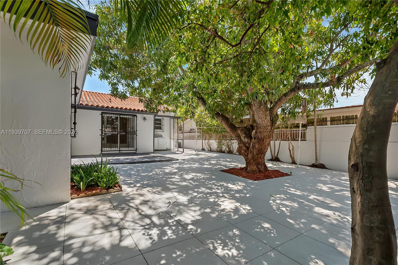 2327 Southwest 22nd Terrace, Unit FRONT Miami, FL 33145 - Photo 27 of 29 a view of a tree in front of a house
