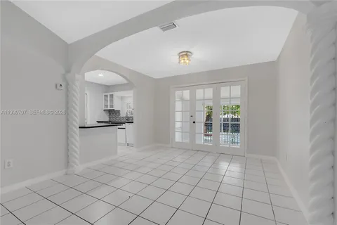 a view of an empty room with a kitchen