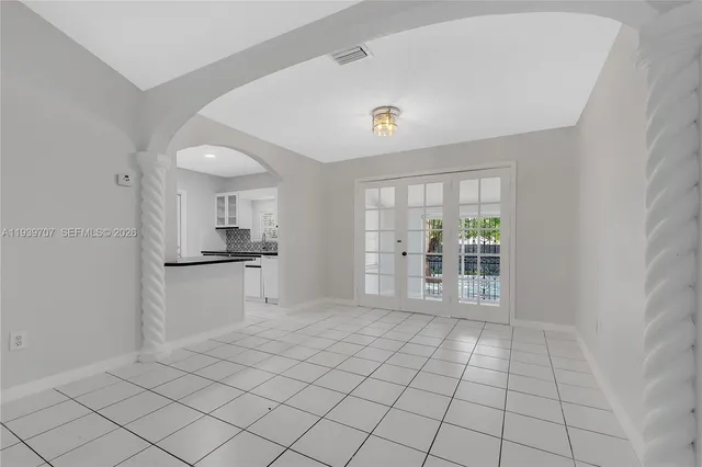 a view of an empty room with a kitchen