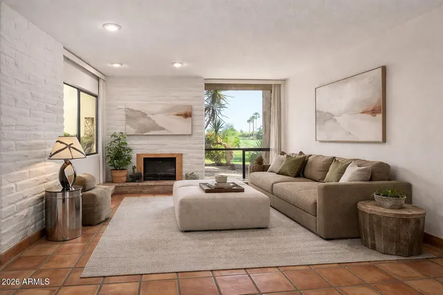 a living room with furniture and a fireplace