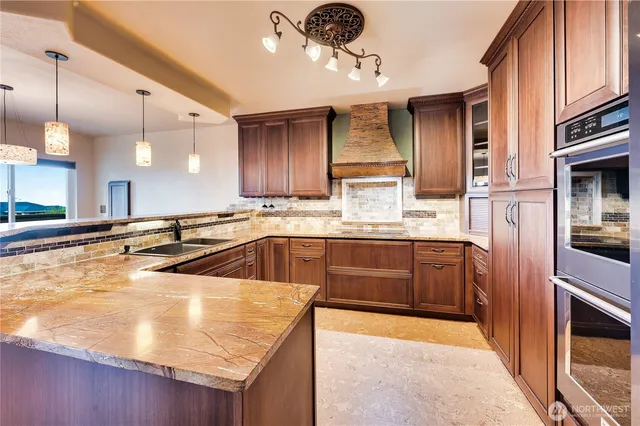 a kitchen with stainless steel appliances granite countertop a sink and cabinets
