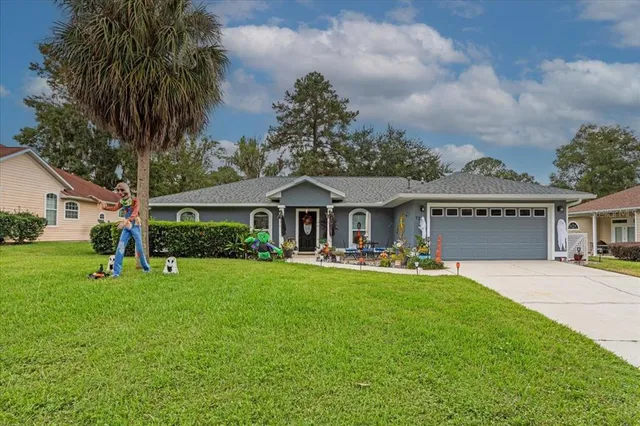 a front view of house with yard and green space