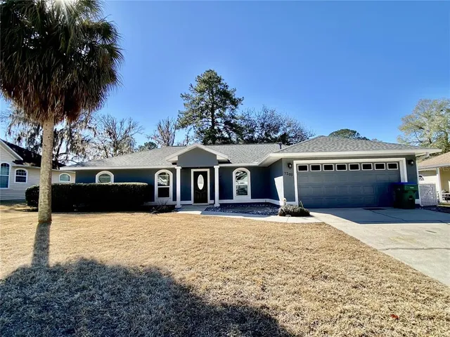 a front view of a house with a yard covered in snow