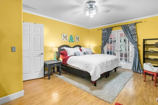 a bedroom with a bed wooden floor and table