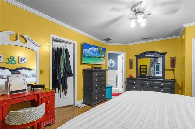 a bedroom with a bed and dresser with mirror