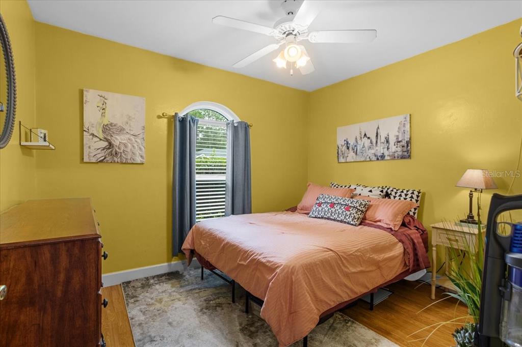 7203 Northwest 121st Avenue Alachua, FL 32615 - Photo 19 of 37 a bedroom with a bed and a chandelier