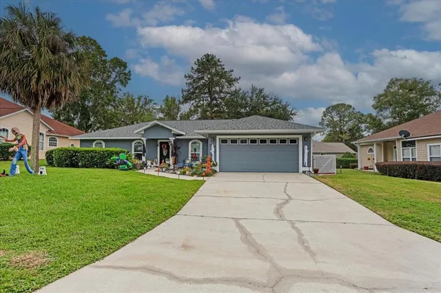 a front view of house with yard and green space