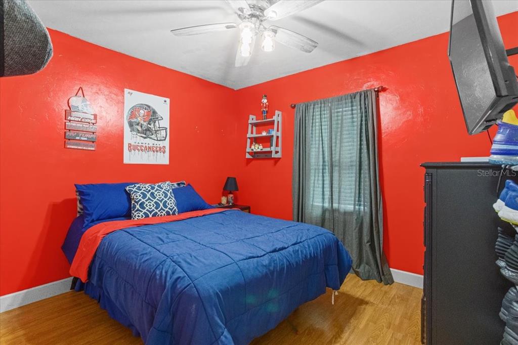 7203 Northwest 121st Avenue Alachua, FL 32615 - Photo 21 of 37 a bedroom with a bed and a chandelier