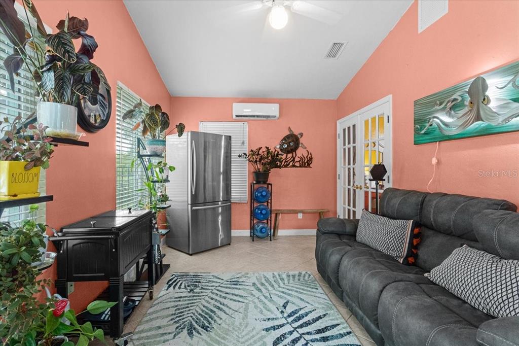 7203 Northwest 121st Avenue Alachua, FL 32615 - Photo 22 of 37 a living room with furniture and a flat screen tv