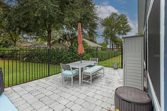 a view of a patio with a dining table and chairs with wooden floor