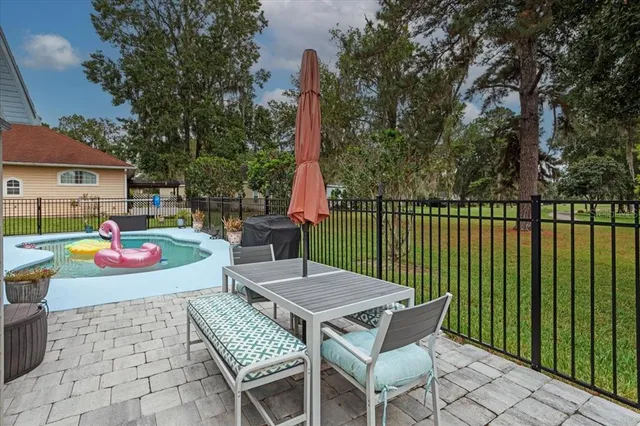 a view of a patio with a table and chairs