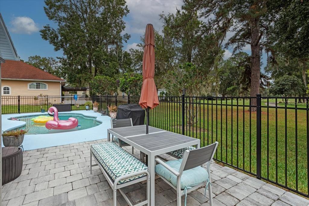 7203 Northwest 121st Avenue Alachua, FL 32615 - Photo 27 of 37 a view of a patio with a table and chairs