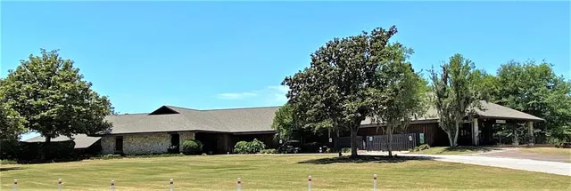 a swimming pool with outdoor seating and yard