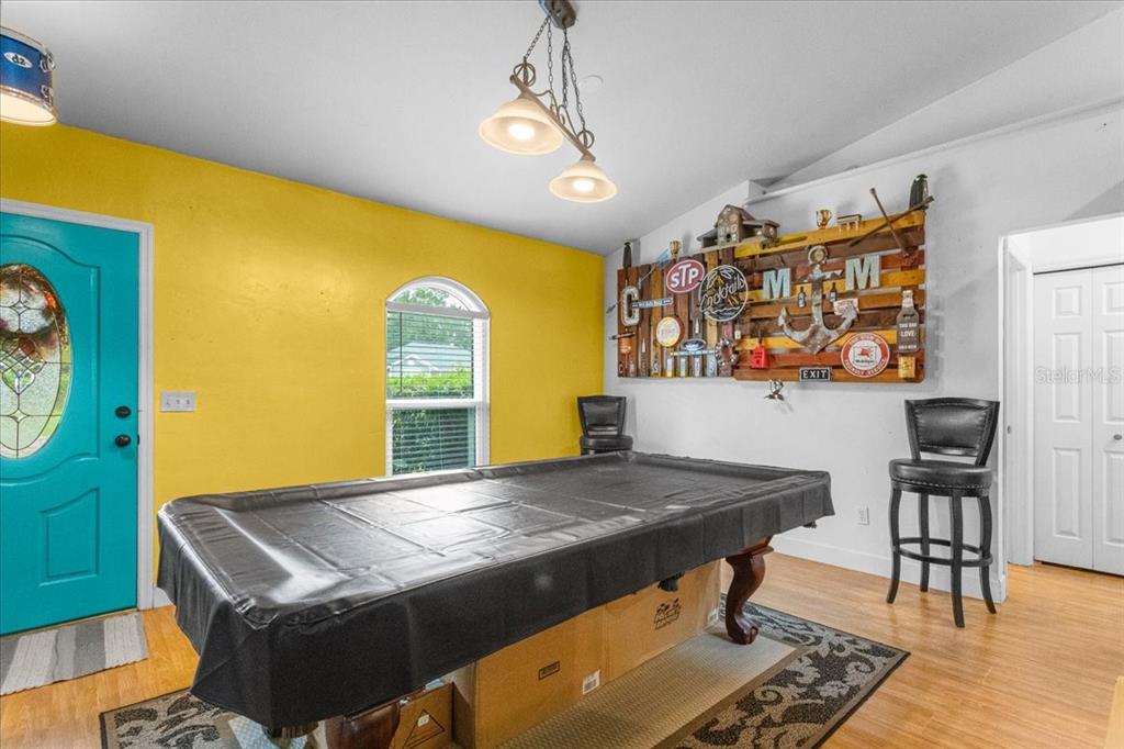 7203 Northwest 121st Avenue Alachua, FL 32615 - Photo 4 of 37 a living room with a table and chairs