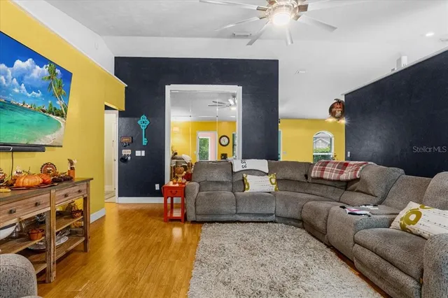 a living room with furniture and a flat screen tv