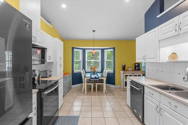a kitchen with a sink a counter top space stainless steel appliances and a window