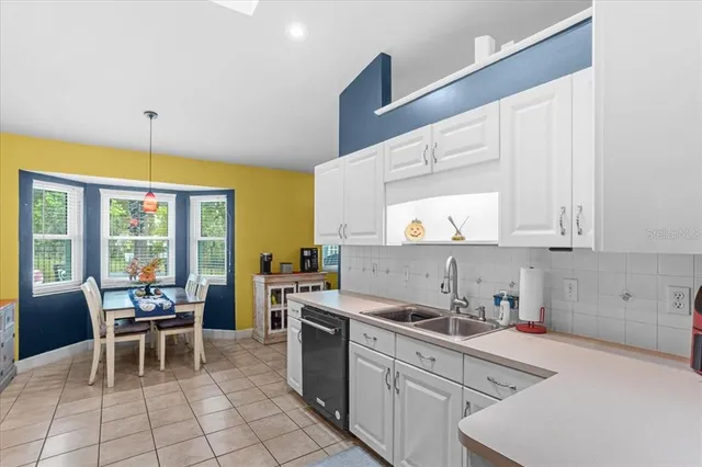 a kitchen with a sink cabinets and window