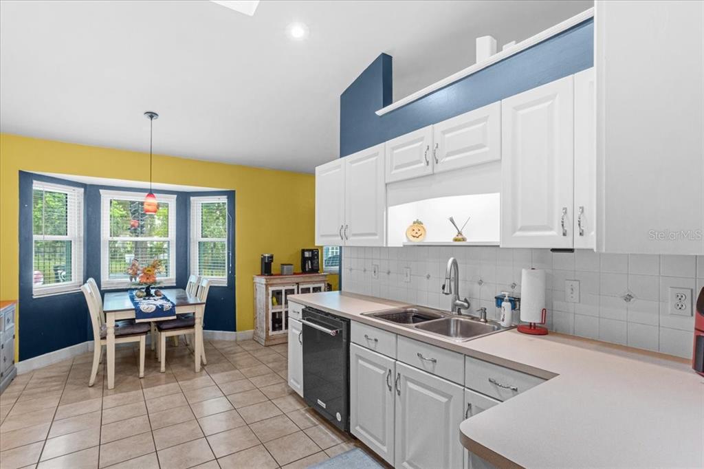 7203 Northwest 121st Avenue Alachua, FL 32615 - Photo 9 of 37 a kitchen with a sink cabinets and window