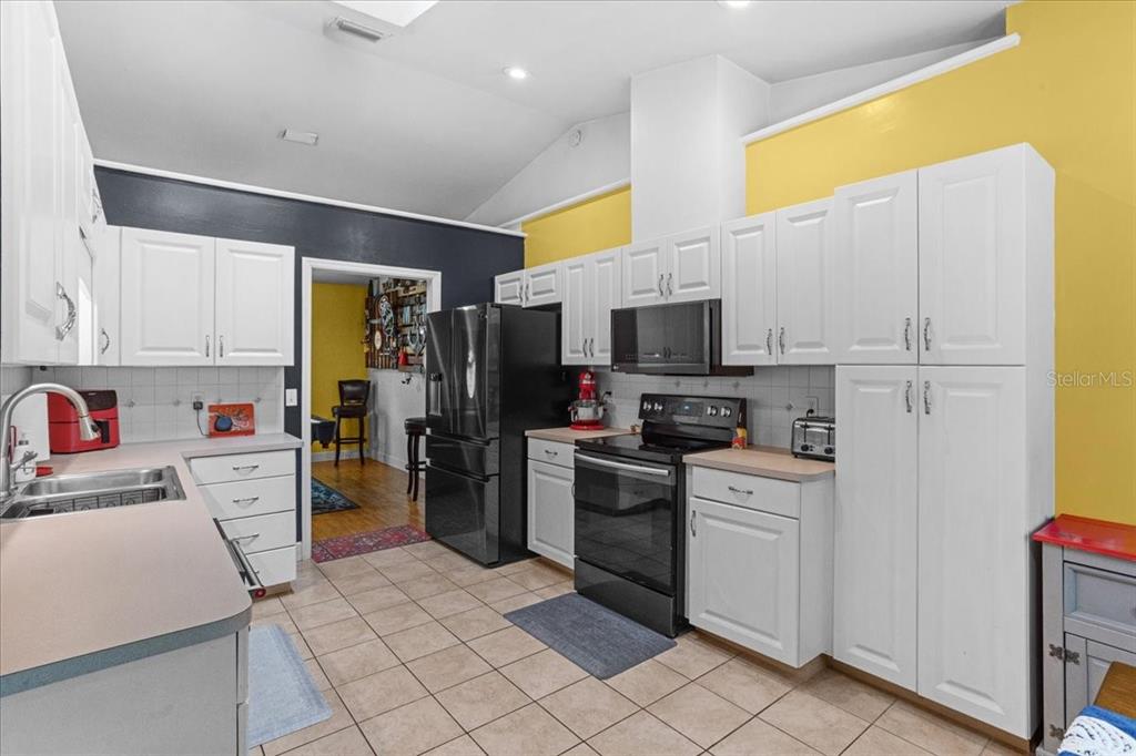7203 Northwest 121st Avenue Alachua, FL 32615 - Photo 10 of 37 a kitchen with stainless steel appliances a refrigerator sink and microwave