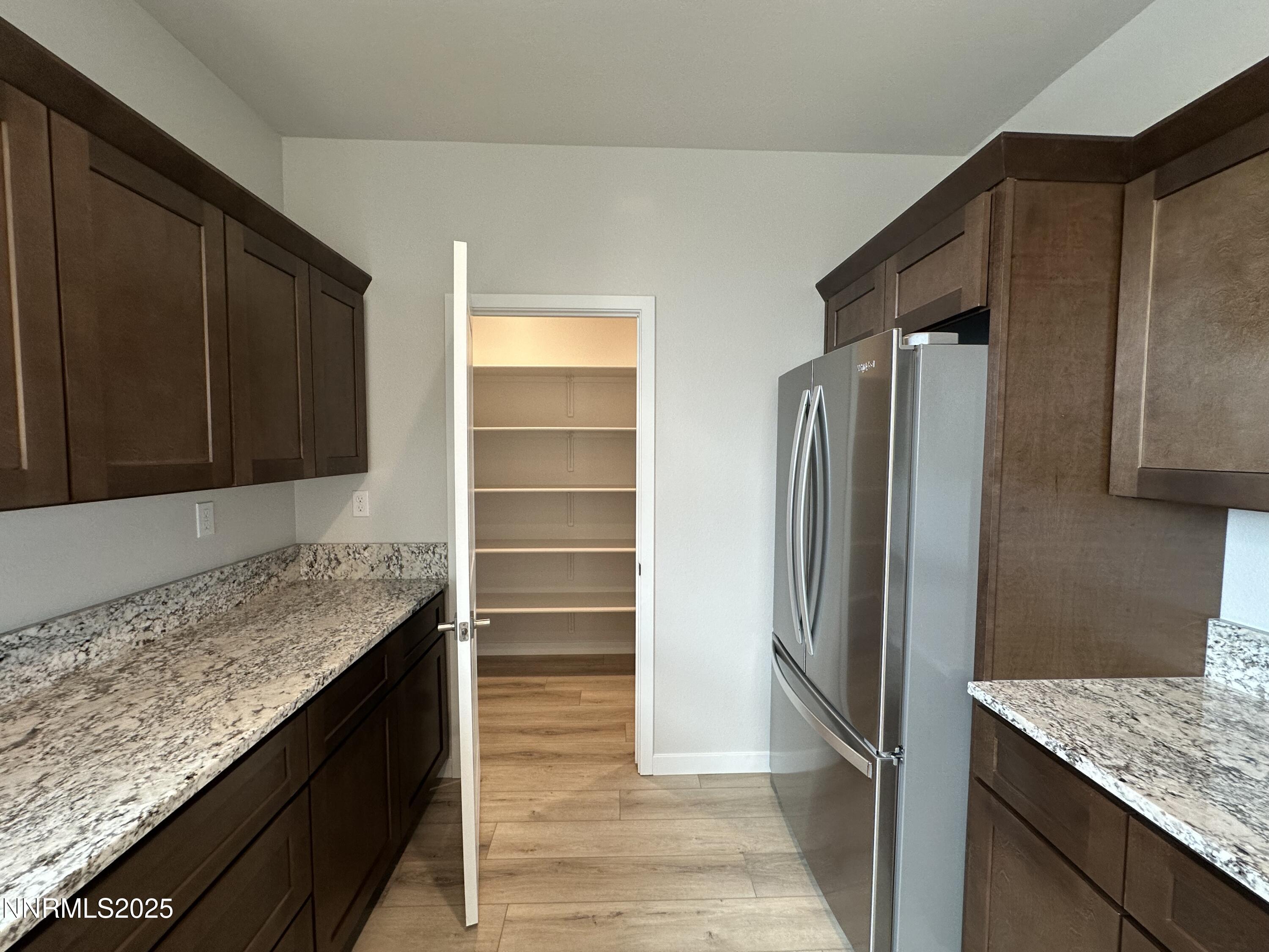 1180 Arrastra Road Reno, NV 89512 - Photo 12 of 48 a kitchen with a refrigerator and countertop