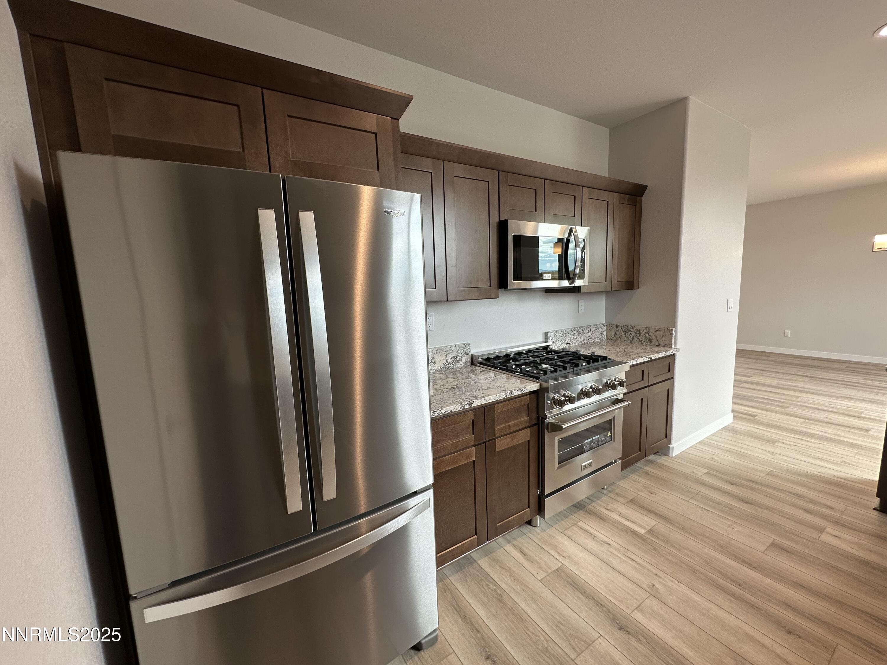 1180 Arrastra Road Reno, NV 89512 - Photo 14 of 48 a kitchen with stainless steel appliances granite countertop a refrigerator stove and sink
