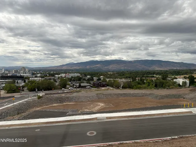 a view of an empty room with a window and a kitchen