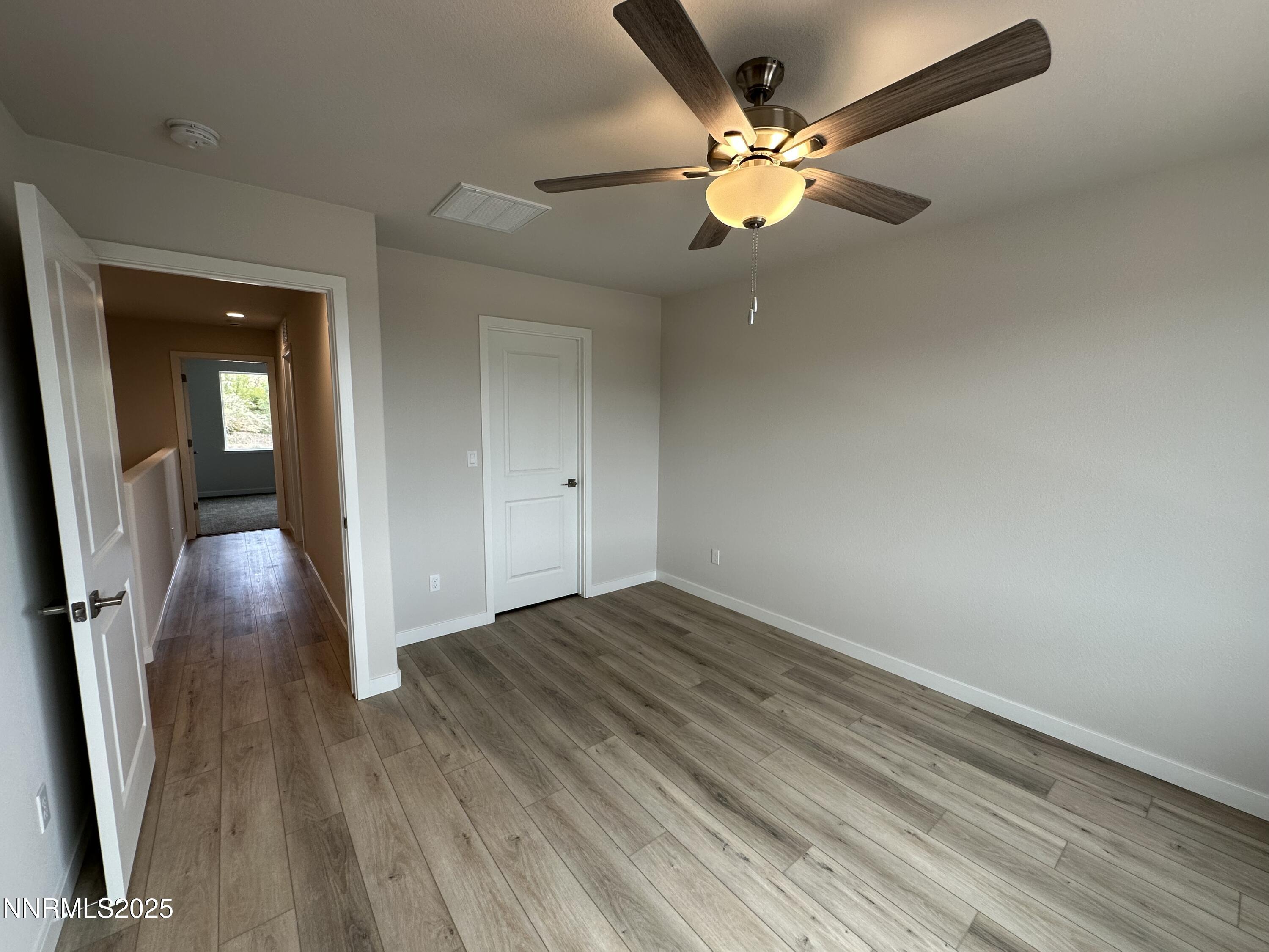 1180 Arrastra Road Reno, NV 89512 - Photo 22 of 48 wooden floor in an empty room with a window