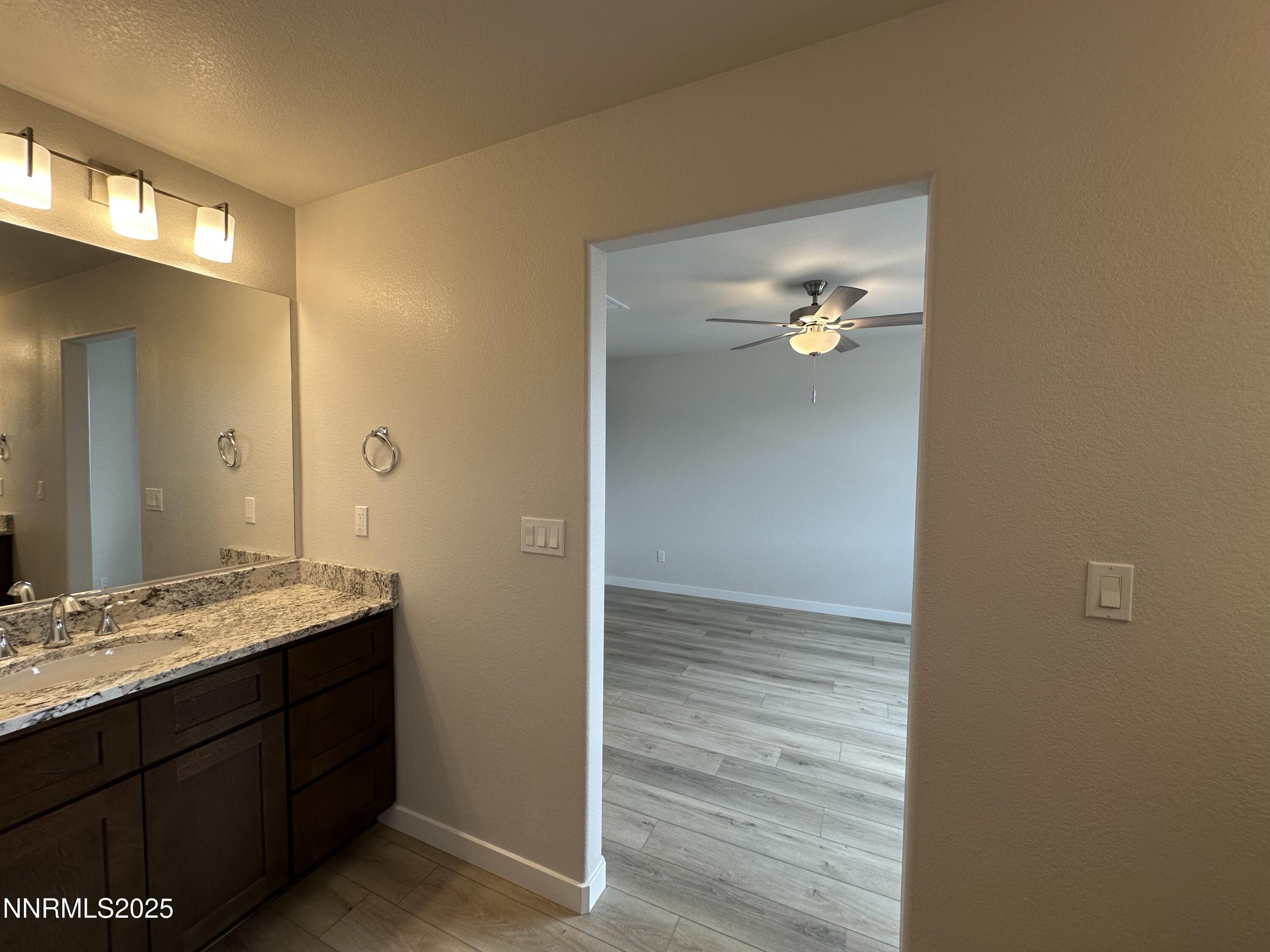 1180 Arrastra Road Reno, NV 89512 - Photo 24 of 48 a bathroom with a granite countertop sink and a mirror