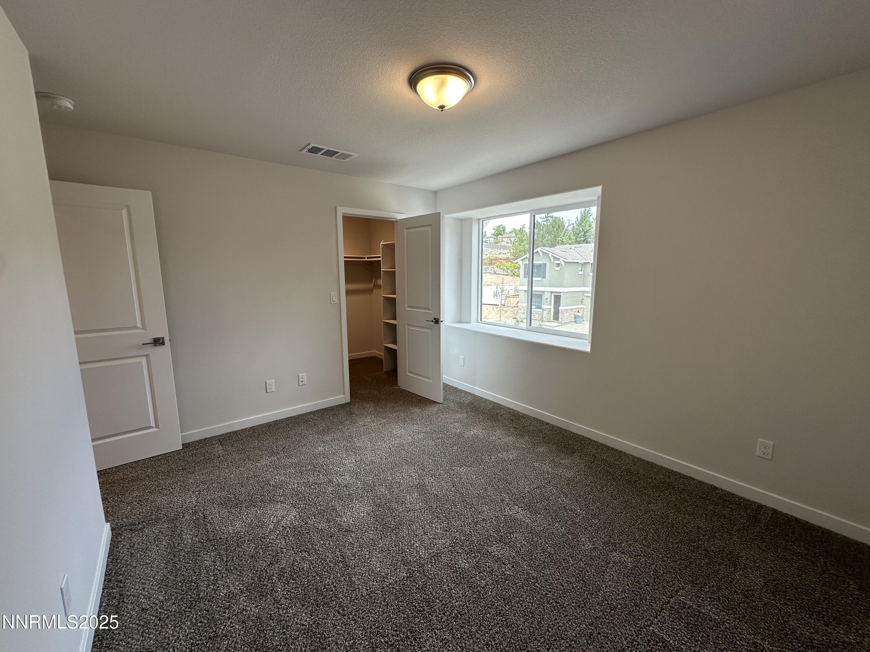 1180 Arrastra Road Reno, NV 89512 - Photo 33 of 48 a view of an empty room with a window and a kitchen