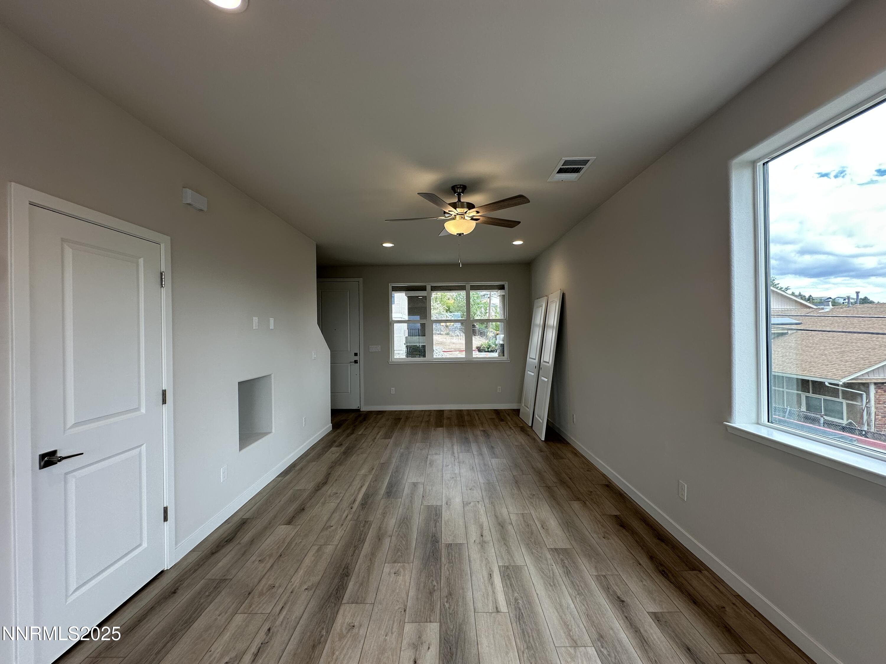 1180 Arrastra Road Reno, NV 89512 - Photo 7 of 48 a view of an empty room with wooden floor and a window