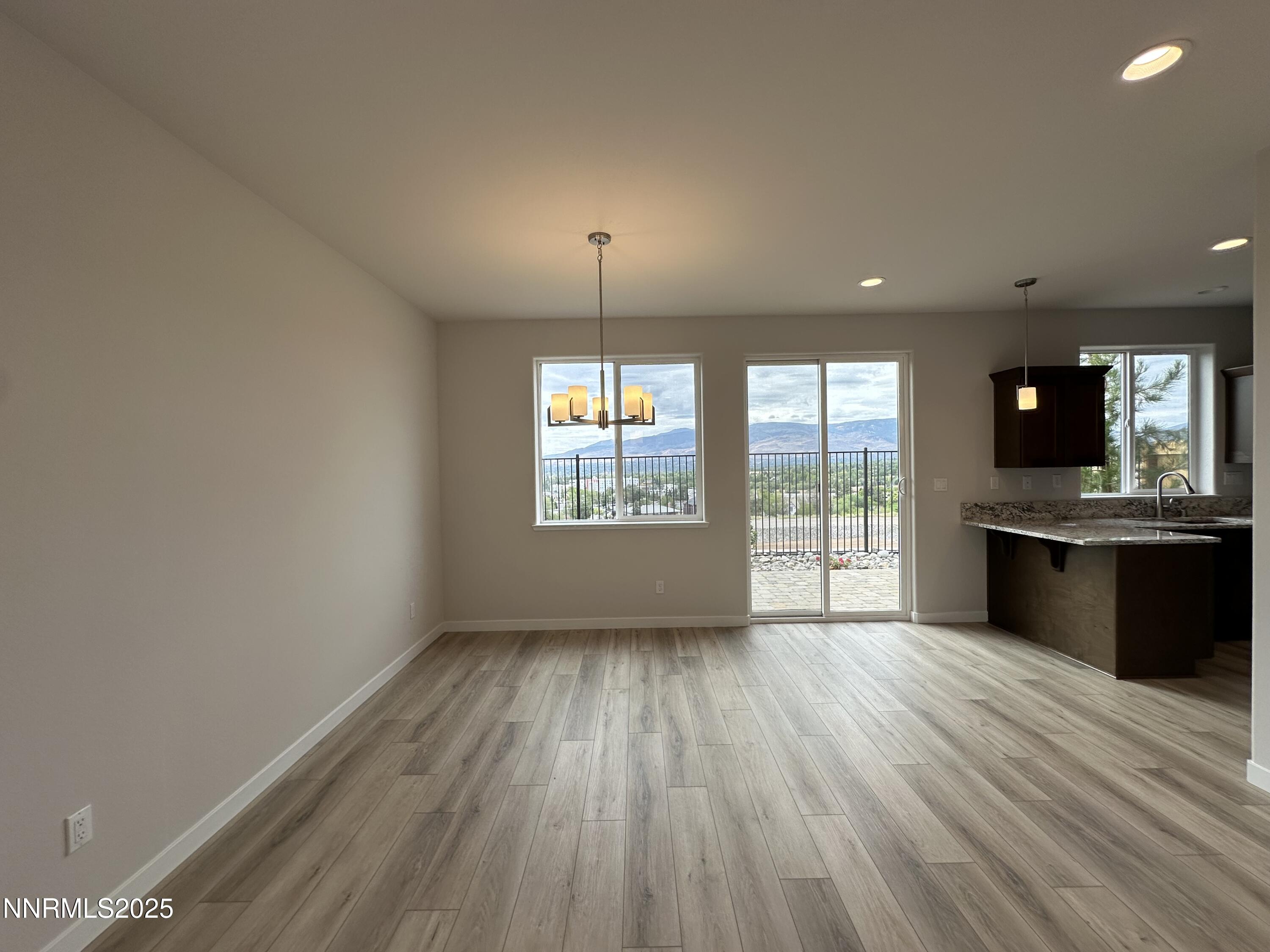 1180 Arrastra Road Reno, NV 89512 - Photo 9 of 48 an empty room with wooden floor and outdoor view