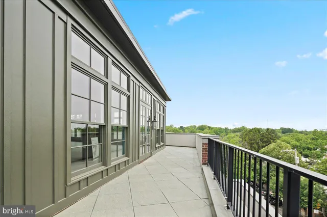 a view of a patio with chairs and potted plants