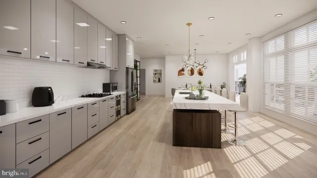 a kitchen with kitchen island granite countertop a sink cabinets and wooden floor