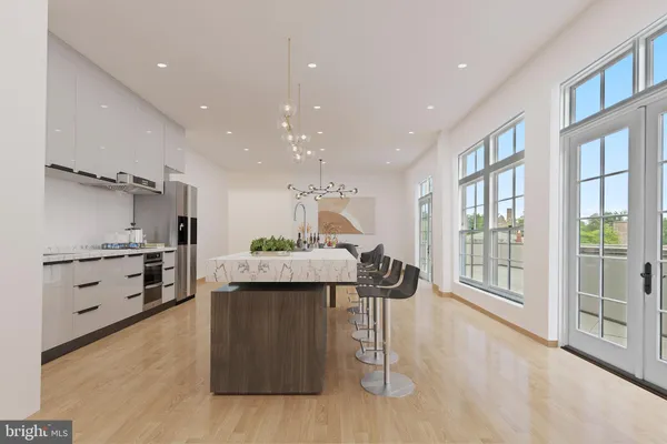 a kitchen with stainless steel appliances kitchen island granite countertop a stove and a refrigerator