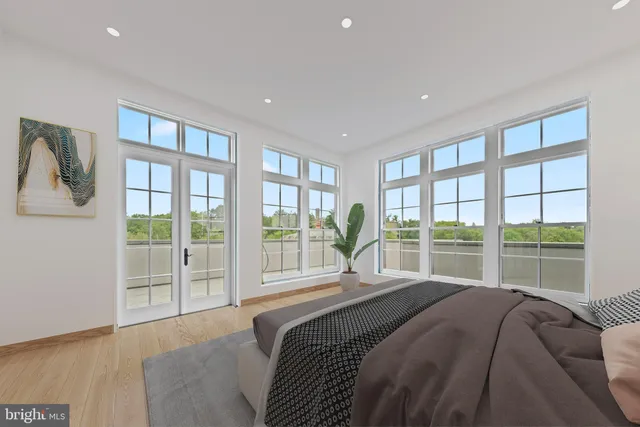 a bed sitting in a bedroom next to a large window