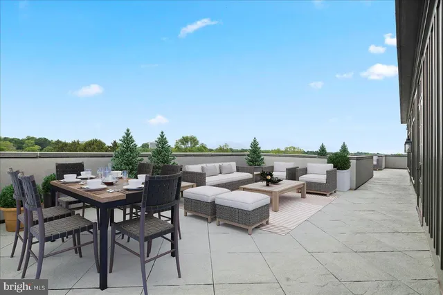 a view of a terrace with furniture and a garden