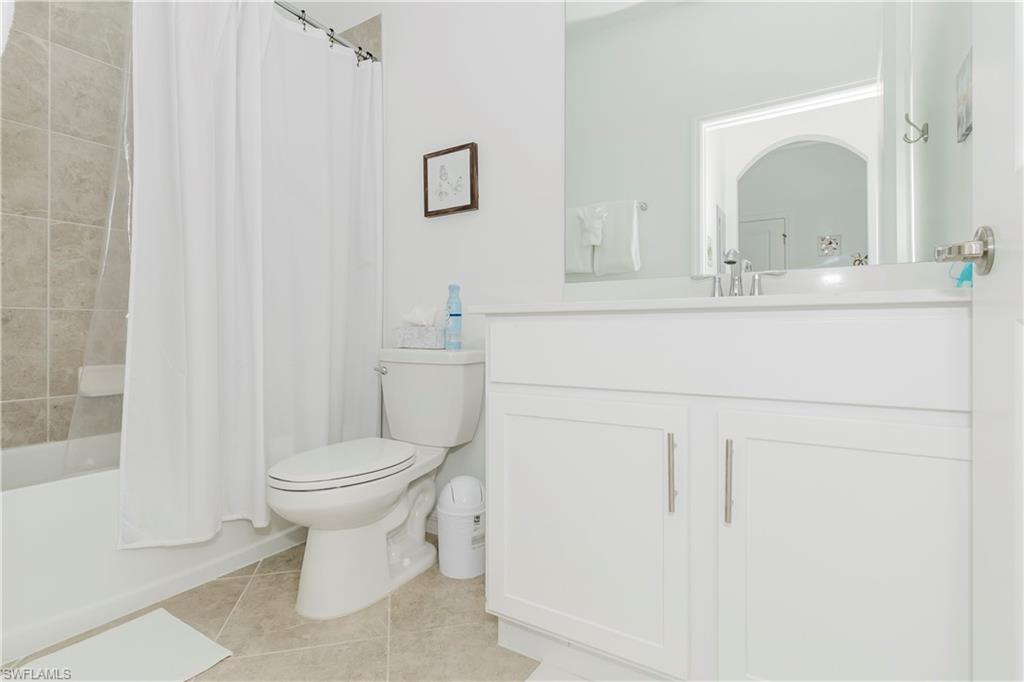 6034 National Boulevard, Unit 542 Ave Maria, FL 34142 - Photo 12 of 36 a bathroom with a toilet sink and mirror