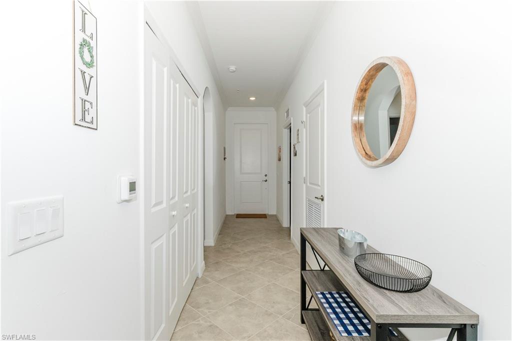 6034 National Boulevard, Unit 542 Ave Maria, FL 34142 - Photo 7 of 36 a spacious bathroom with a granite countertop sink and a mirror