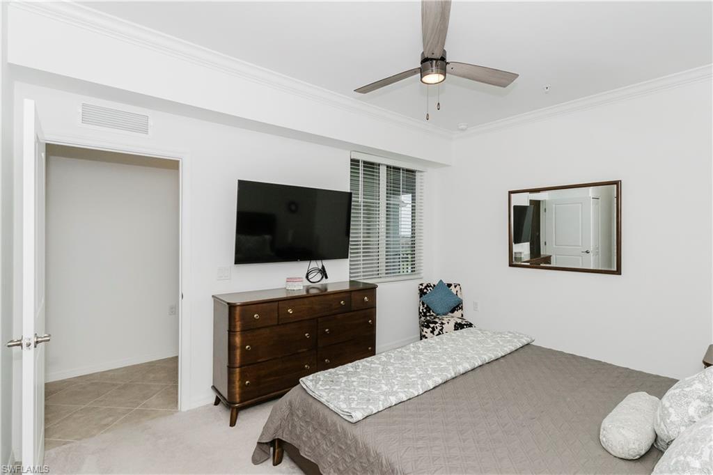 6034 National Boulevard, Unit 542 Ave Maria, FL 34142 - Photo 8 of 36 a bedroom with a bed and a flat screen tv