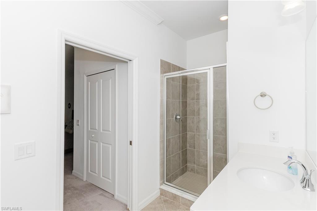 6034 National Boulevard, Unit 542 Ave Maria, FL 34142 - Photo 10 of 36 a bathroom with a sink and shower