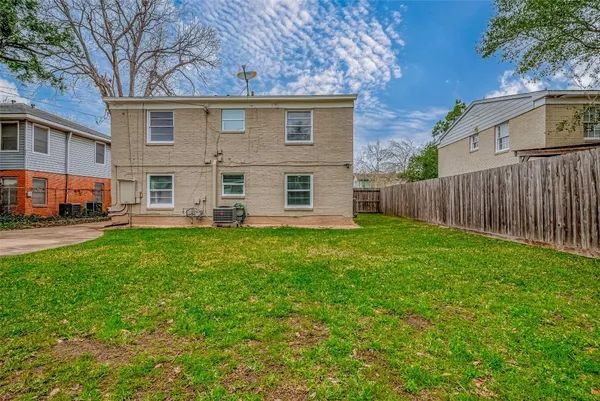a view of a house with a yard and sitting area