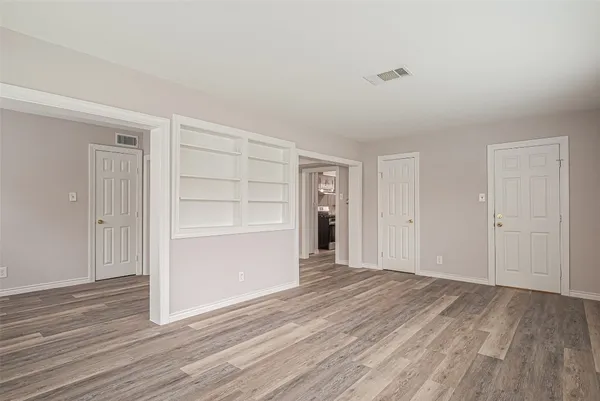 a view of a room with wooden floor and closet