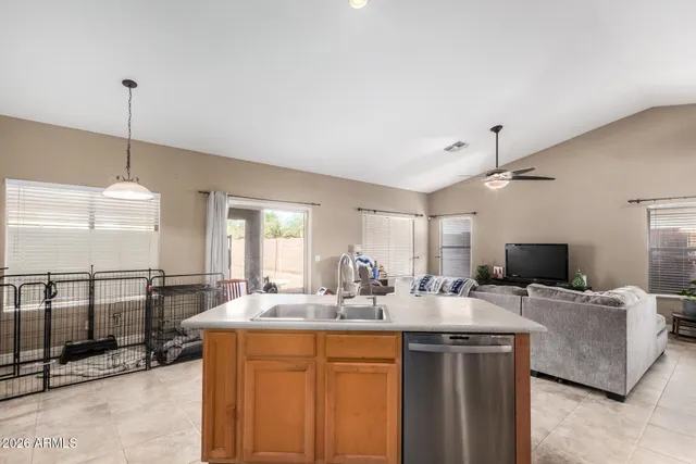 a kitchen with stainless steel appliances kitchen island granite countertop a sink and a granite counter tops